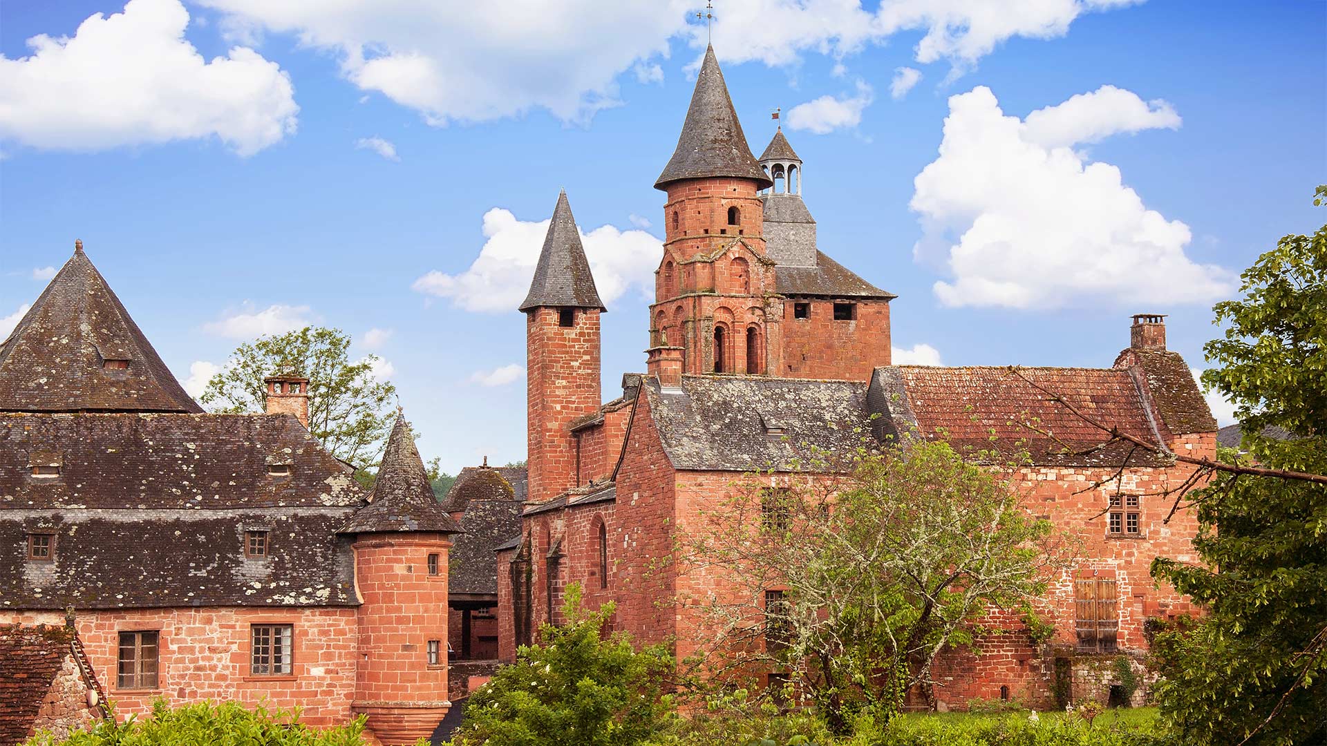 iStock-818844520H Collonges-la-Rouge : vue sur le Castel de Vassinhac et l'église Saint-Pierre (Nouvelle-Aquitaine, France)